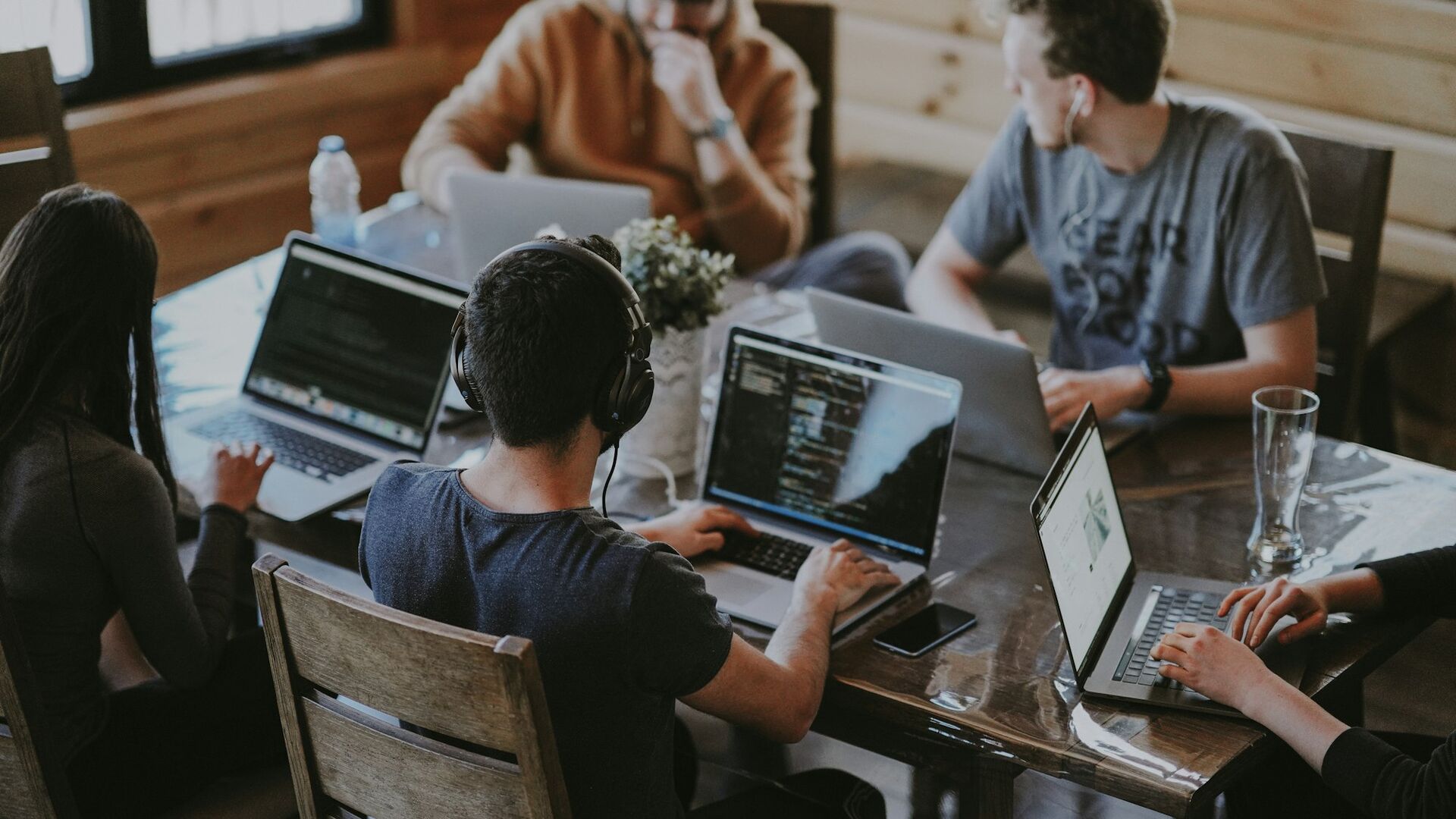 A small team working side by side on laptops